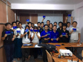 alt Group Photo at the end of Fedora 23 Release + Translation Workshop in Myanmar; Everyone is holding Fedora 23 Workstation Live DVD (64bits) in hand.
